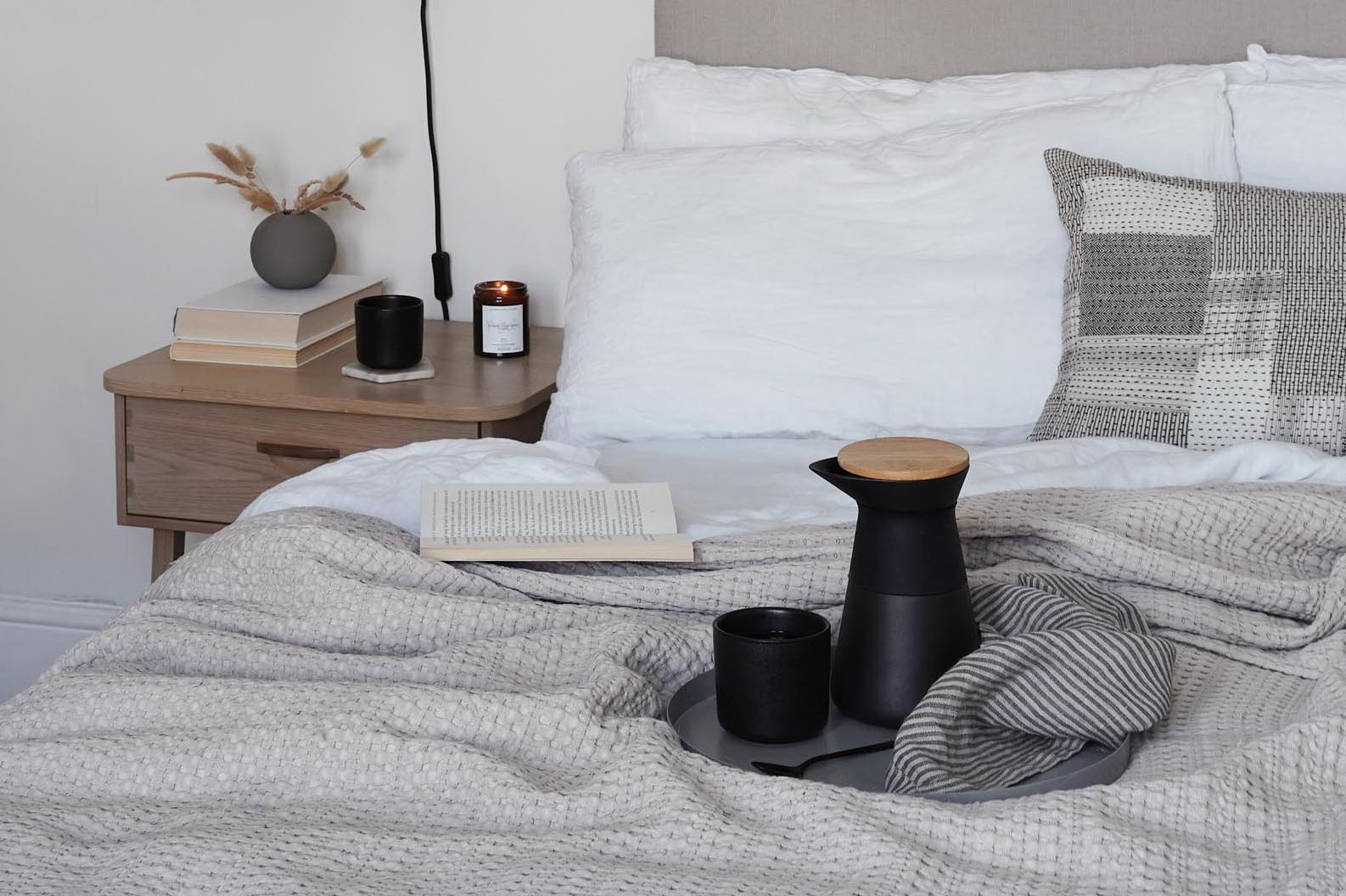 Breakfast in bed in a minimalist beige bedroom | These Four Walls blog
